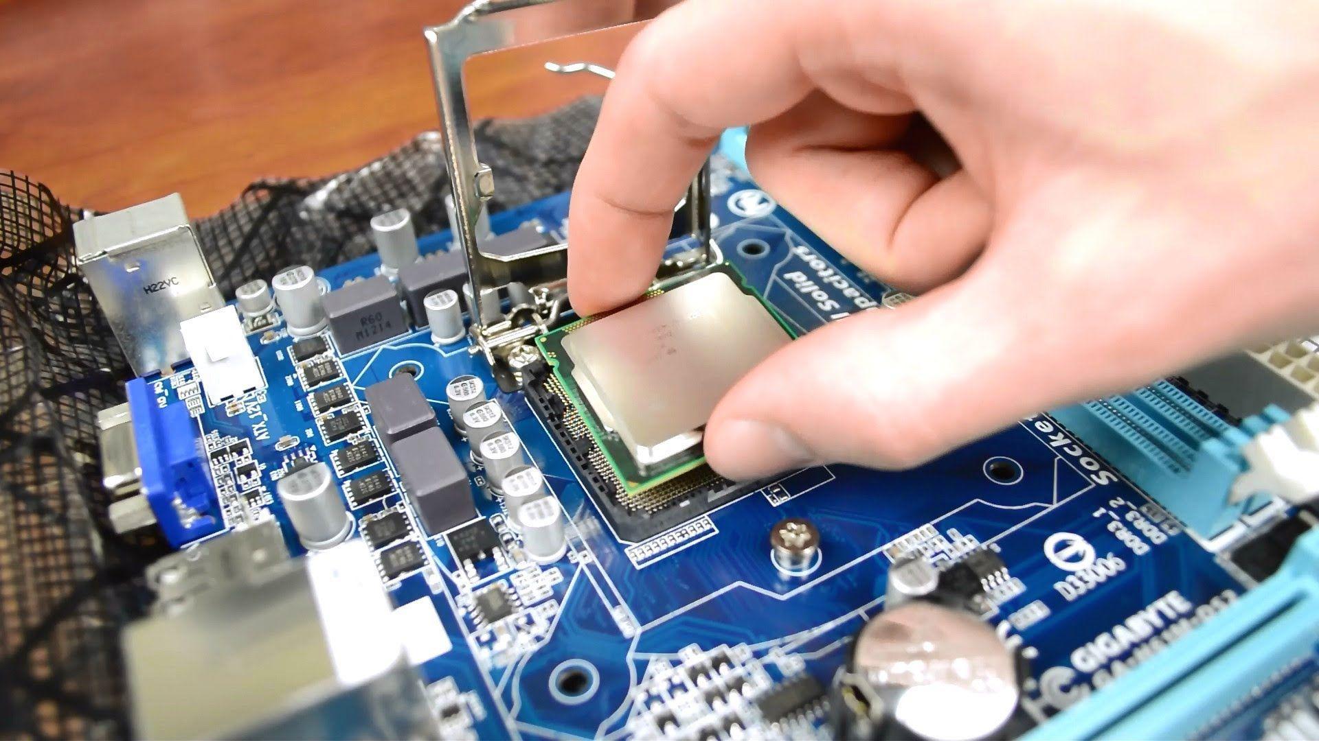 Technician repairing computer hardware at workstation